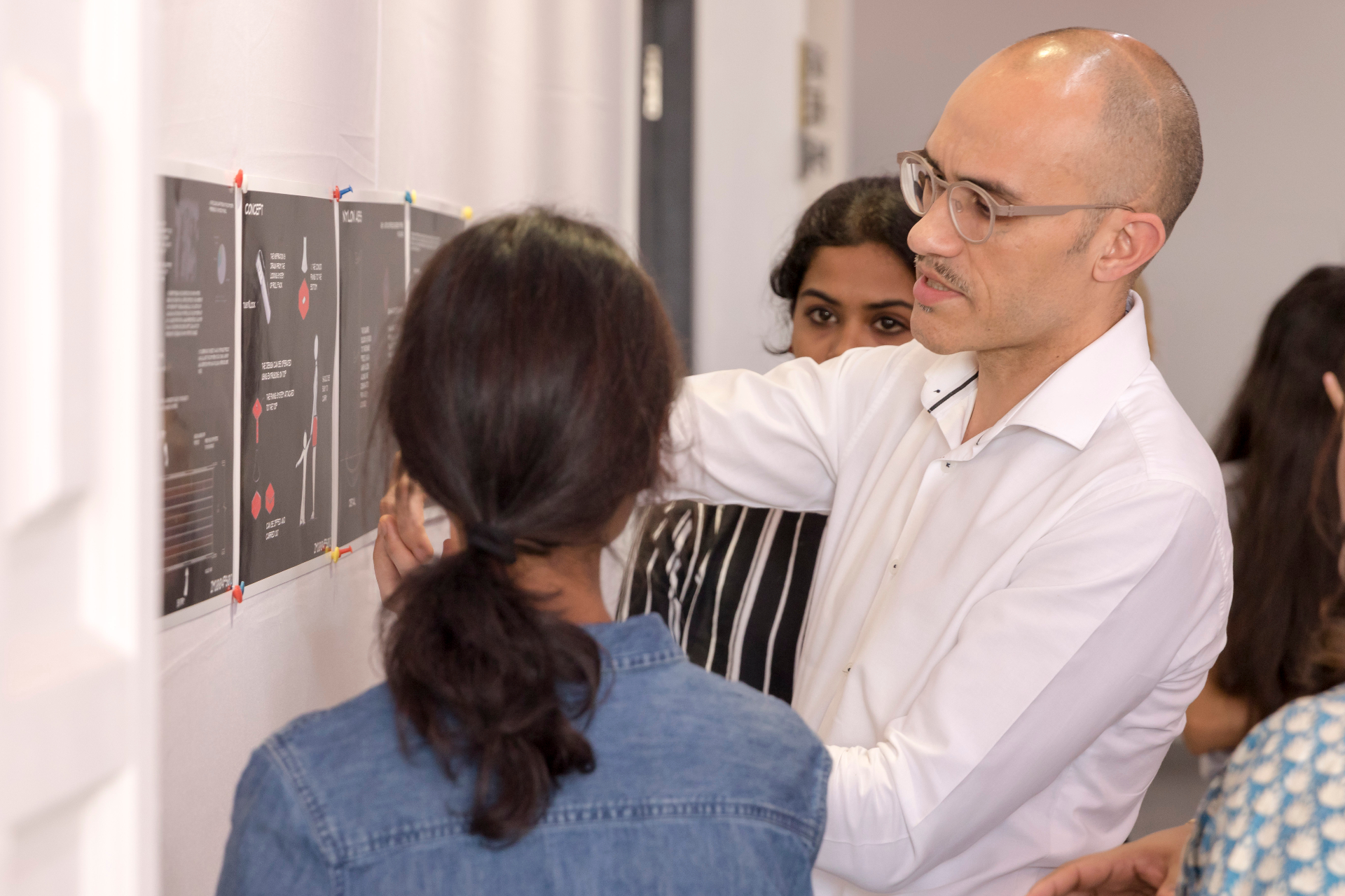 International Mentors engaging with students on design projects
