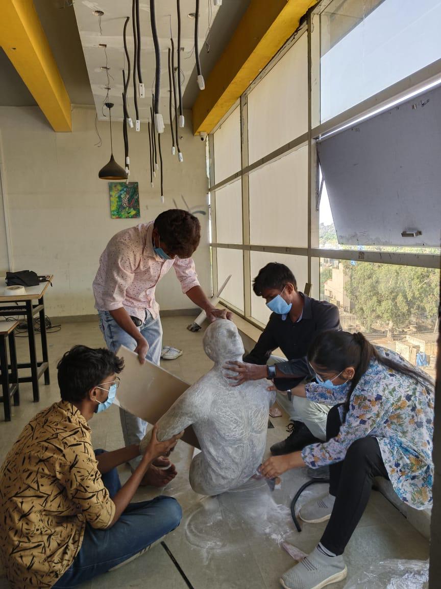 Students working together on a sculpture project in the studio space